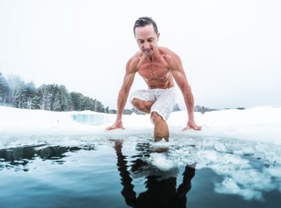 man with lean muscular body going to swim in the cold winter water