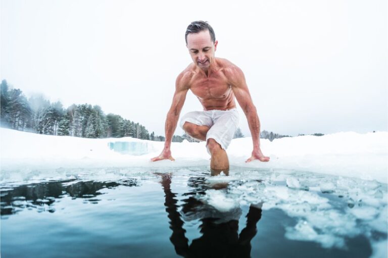 man with lean muscular body going to swim in the cold winter water